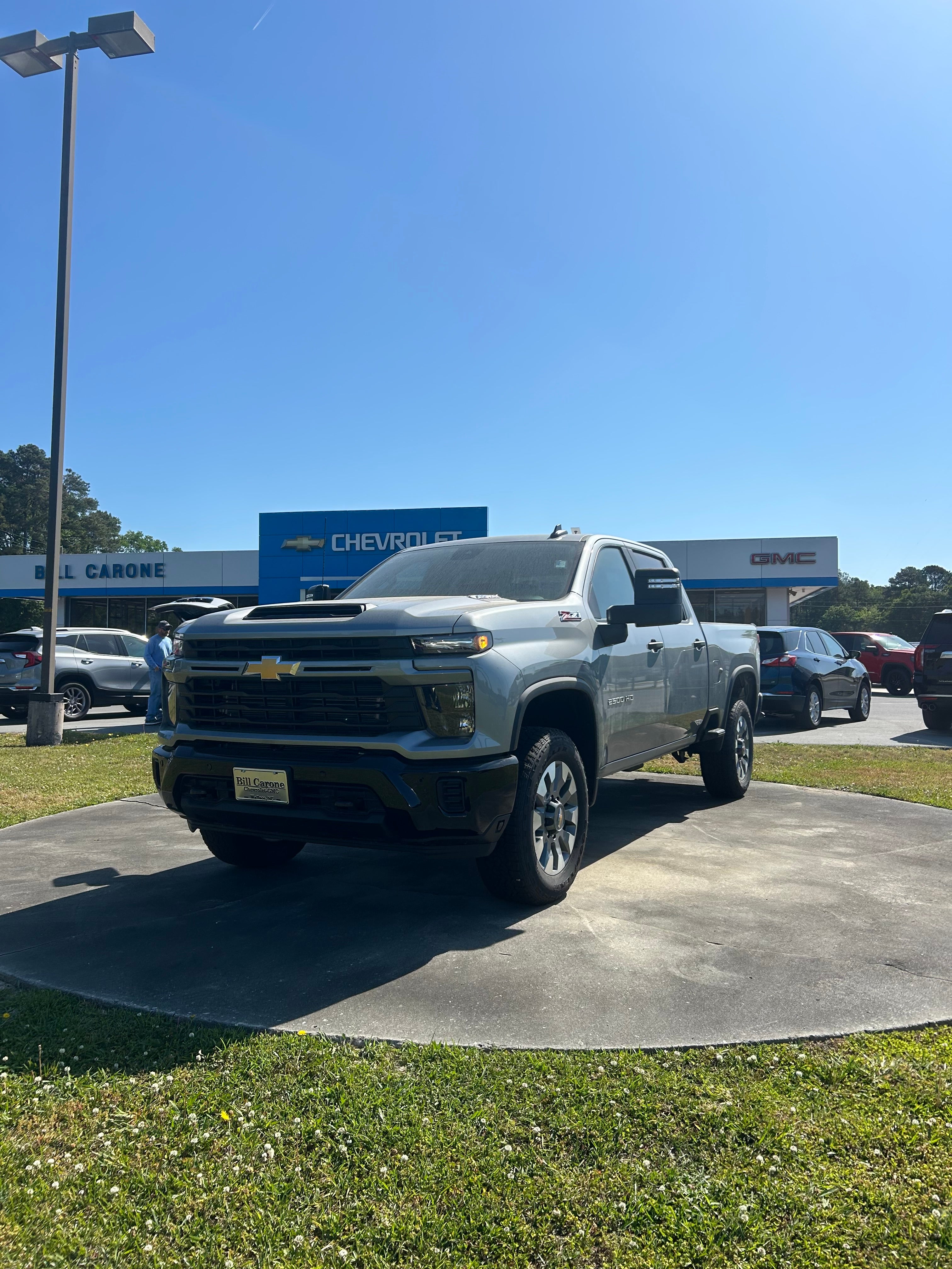 2026 Chevrolet Silverado 2500 HD Custom in Sterling Gray Metallic — front three-quarter view